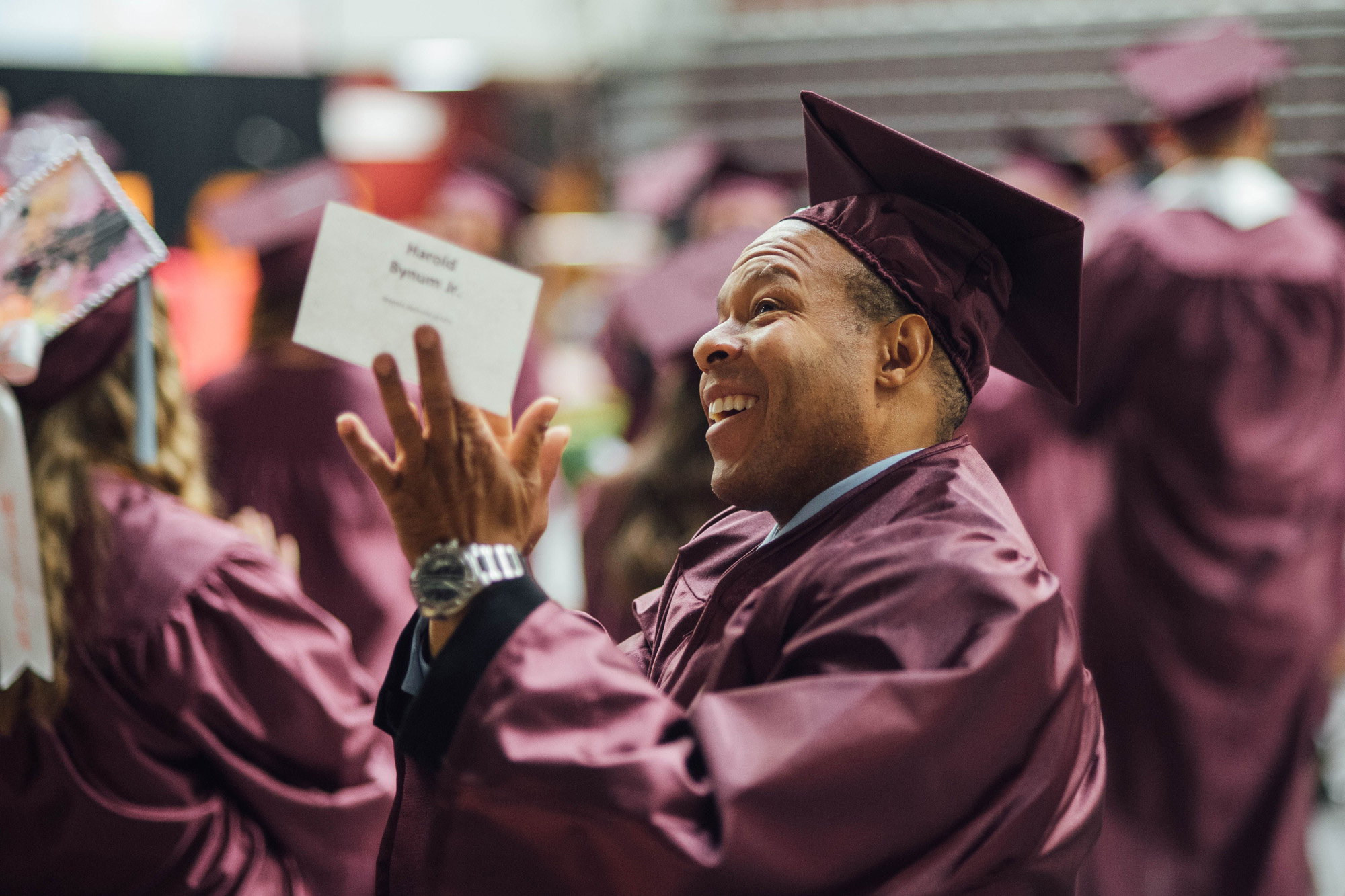 Grad applauding in crowd.