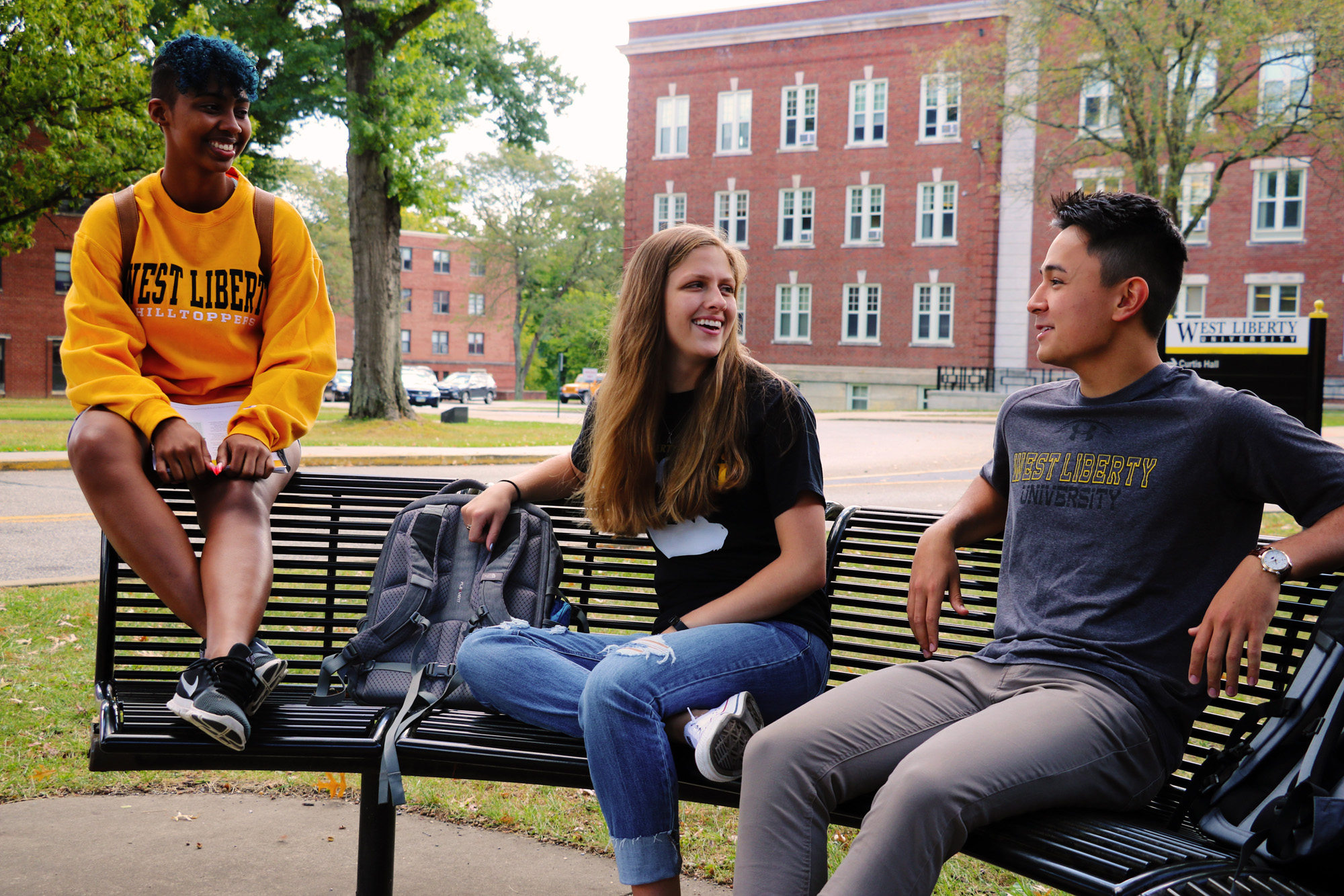 Students sitting on benches.