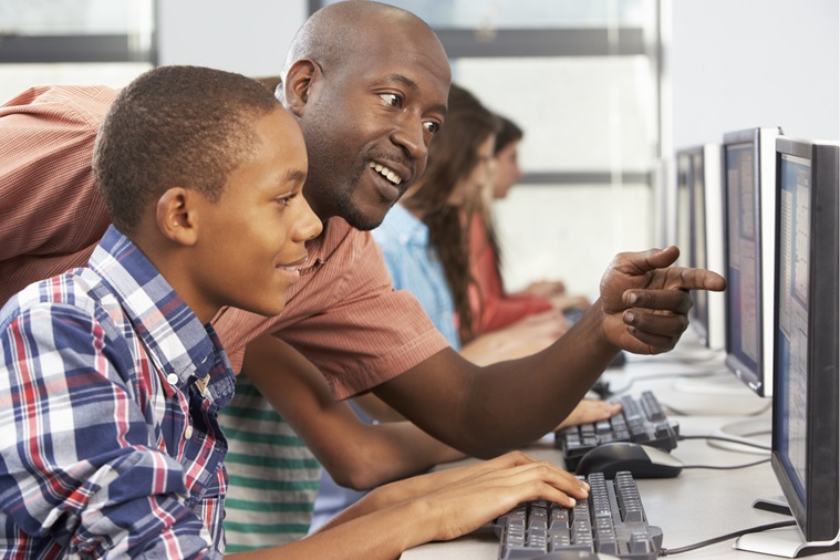 Man pointing at a student's computer screen.
